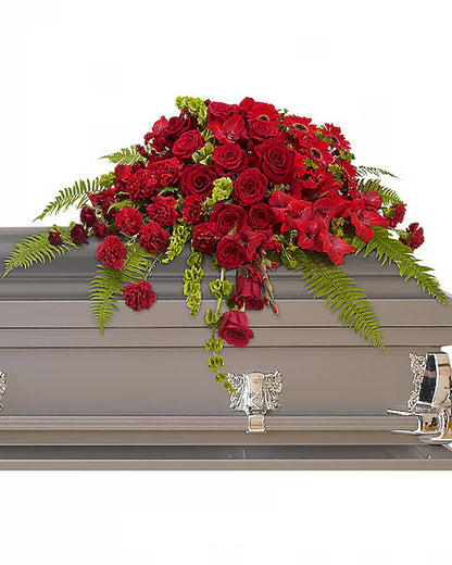 Grey casket adorned with red flowers