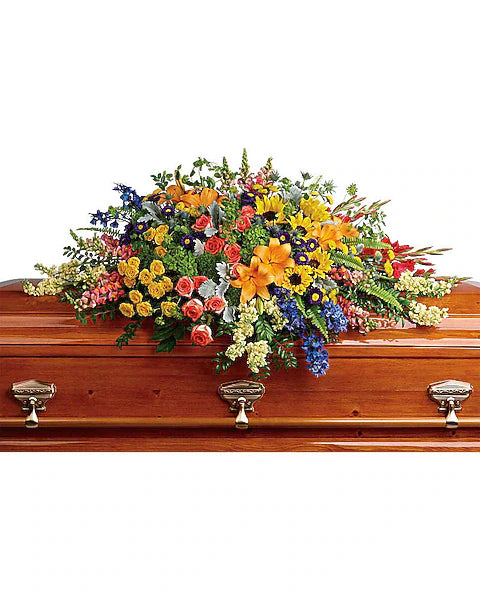 Wooden casket with a colorful floral arrangement on a white background