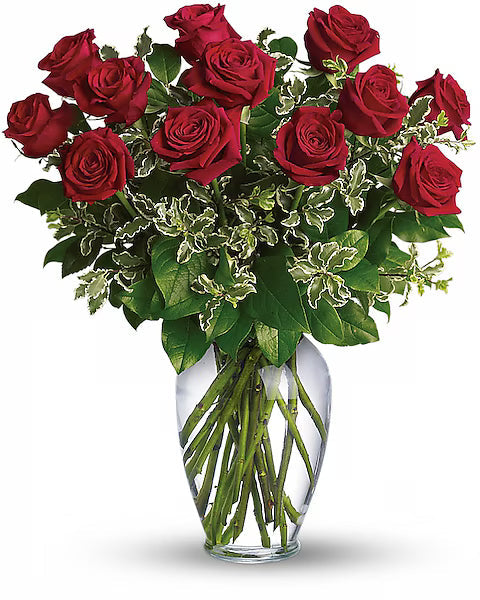 Bouquet of red roses in a clear vase on a white background