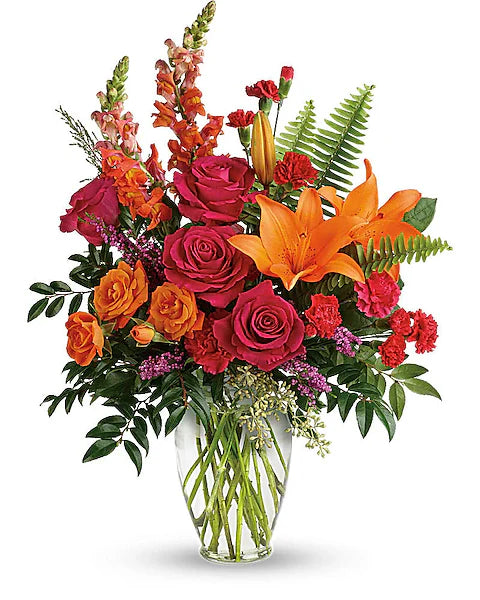 Fresh floral arrangement of roses, lilies, and mixed flowers in vase