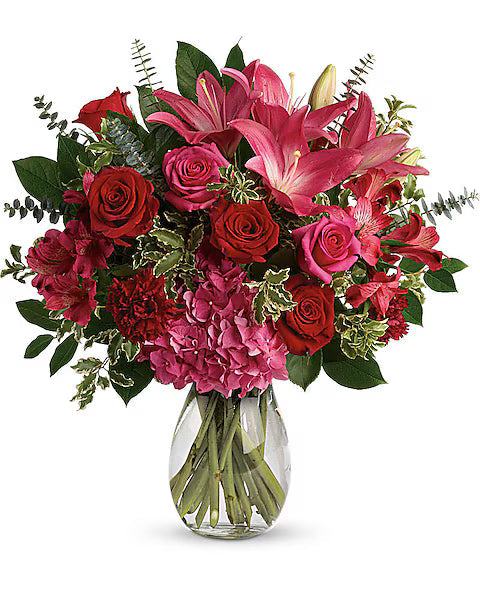 Bouquet of red and pink flowers with glass vase