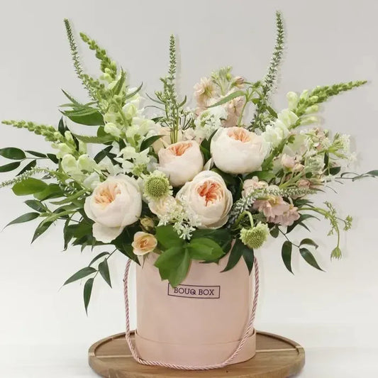 Floral arrangement in a pink box